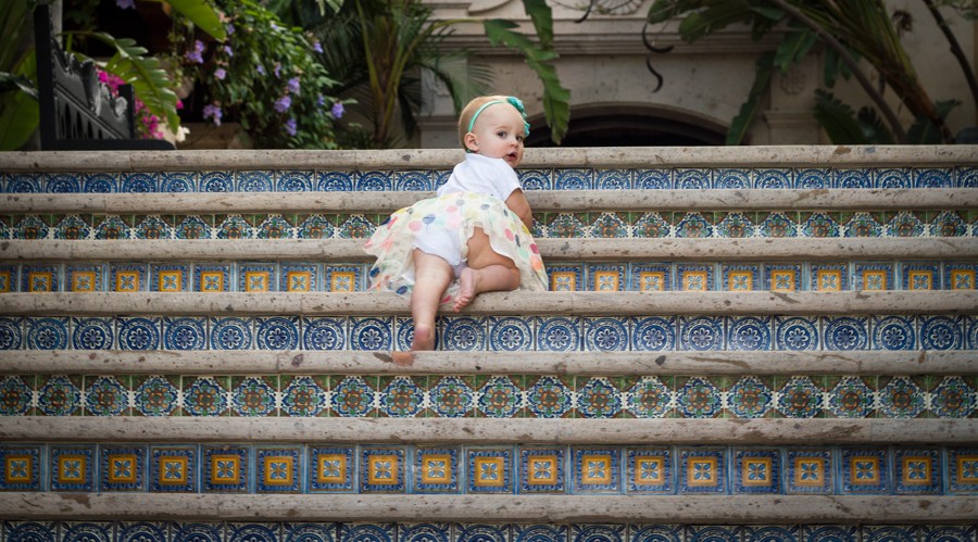 first birthday shoot baby climbing stairs